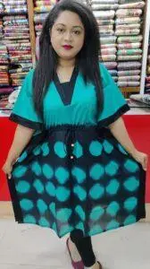 Woman Entrepreneur showcasing dress in her store