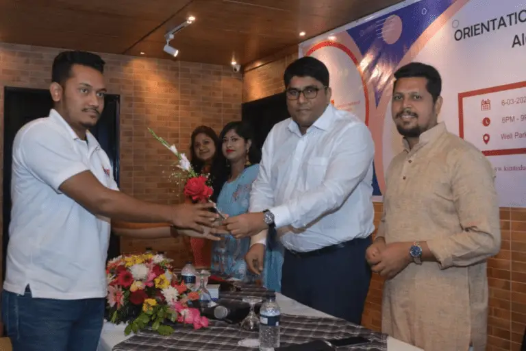 The business owner giving flowers to a student in orientation program