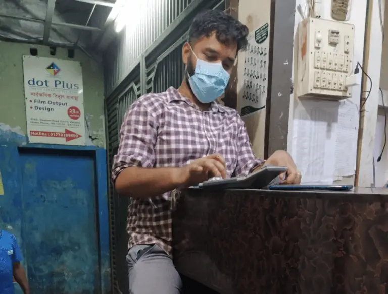 The businessman using calculator in his shop.